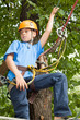 Young boy engaged in climbing with tree.