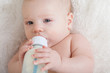Closeup portrait of a baby with a bottle.