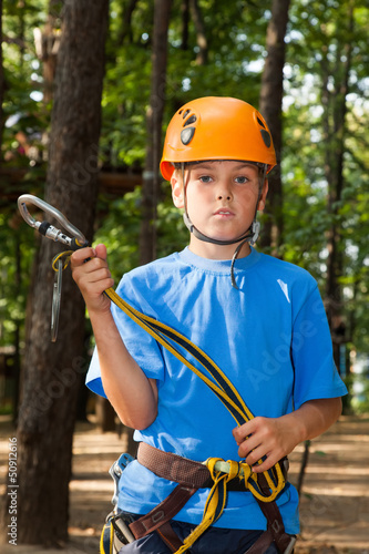 Photo: Young guy with equipment climber holding anchor. Young guy with equipment climber holding anchor.
