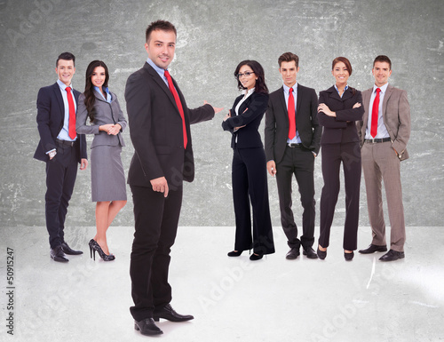 Photo: business team being presented by a young leader business team being presented by a young leader