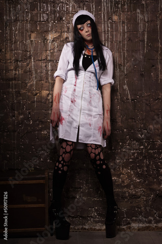 Photo: Crazy dead nurse with knife in the hand Crazy dead nurse with knife in the hand