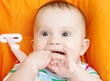 Happy baby sitting on babies chair age of 6 month