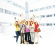 Group of smiling teenagers staying together and looking at camer