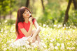 Cute woman in the park with dandelions