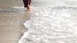 Woman feet walking on the beach