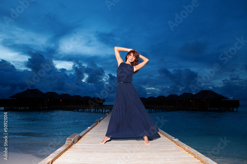 Photo: Fashion woman on the sea sunset background Fashion woman on the sea sunset background