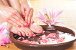 Spa background with a beautiful legs, flowers and petals
