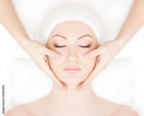 Photo: Portrait of a young woman relaxing on a spa massage Portrait of a young woman relaxing on a spa massage