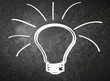 Light bulb on blackboard background