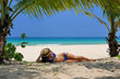 Woman at beach under palm tree