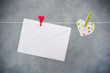 letter and heart hanging on the clothesline on a gray background