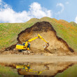 An excavator in old mine. Damaged landscape concept.