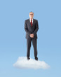 Foto: Senior business man standing on a cloud Senior business man standing on a cloud