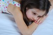 Young child, lying awake in his bed
