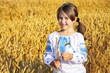 small rural girl on wheat field
