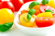 Assorted colorful red and yellow cherry tomatoes in plate on tab