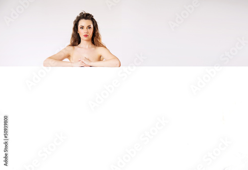 Photo: Naked brunette lady behind the board Naked brunette lady behind the board