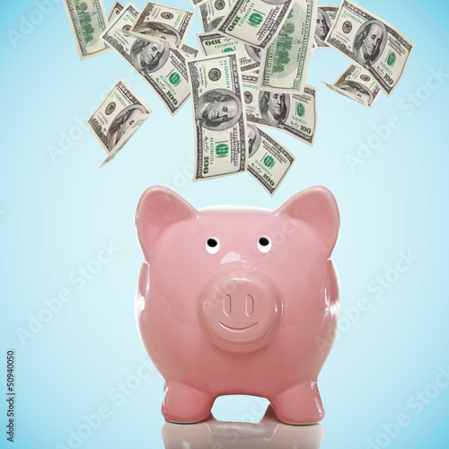Photo: Piggy bank with hundred dollar bills Piggy bank with hundred dollar bills