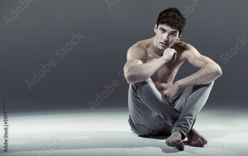 Photo: Athlete young man in sexy pose Athlete young man in sexy pose