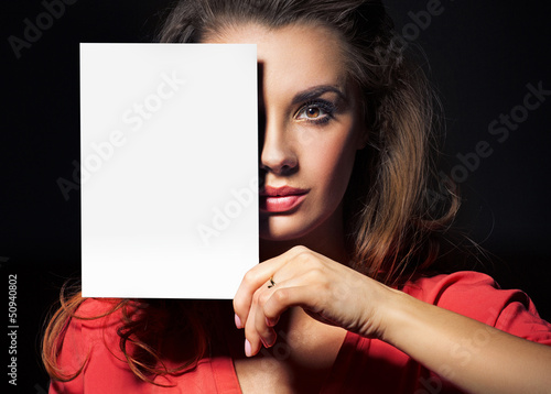 Photo: Beautiful lady holding an empty white sheet Beautiful lady holding an empty white sheet