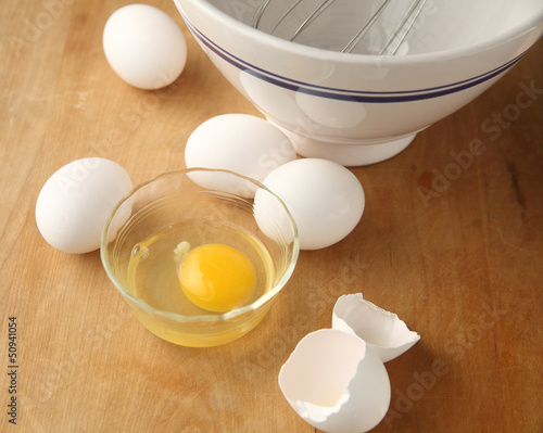 Photo: mixing bowl with whisk and eggs, one broken mixing bowl with whisk and eggs, one broken