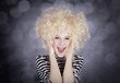 Portrait of funny girl in blonde wig. Studio shot.