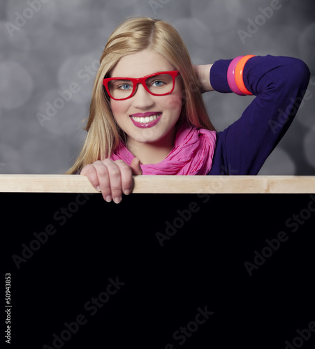 Photo: Smiling teen girl with blackboard. Smiling teen girl with blackboard.