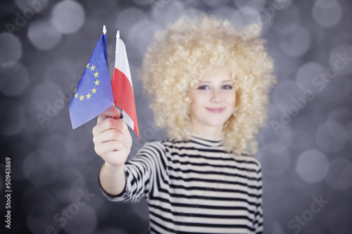 Photo: Beautiful girl with ringlets show European Union and Poland flag Beautiful girl with ringlets show European Union and Poland flag