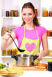 Young woman cooking in kitchen