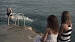 Friends jumping into water with girlfriends applause