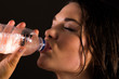 Sports women drinking bottle of water