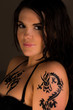 Beautiful female with tribal dragon tattoo