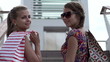 Happy female friends with shopping bags, super slow motion