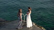 Girlfriends standing by the water, super slow motion