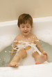 The boy splashes in a bathroom