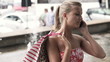 Woman talking on cellphone in the city, super slow motion