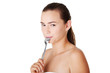 Teen girl with spoon in mouth.