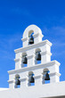 White bell tower santorini style with clear blue sky