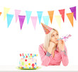 Sad birthday girl with a cake