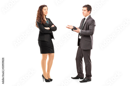 Photo: Full length portrait of a young businesspeople having a conversa Full length portrait of a young businesspeople having a conversa