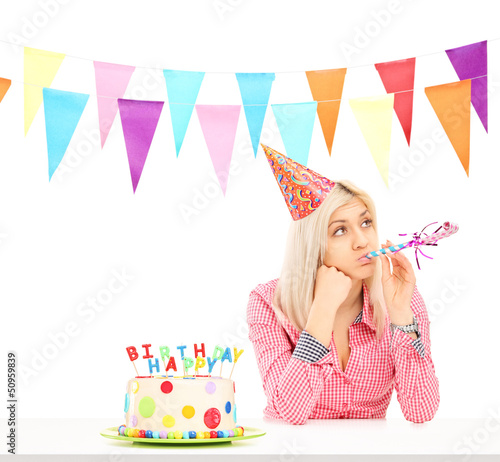 Photo: Sad birthday girl with a cake Sad birthday girl with a cake