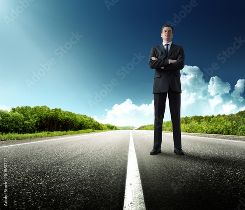 Photo: business man stay on the road business man stay on the road