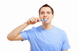 Young man at home brushing teeth