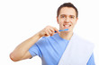 Young man at home brushing teeth