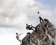 Three business people pulling rope