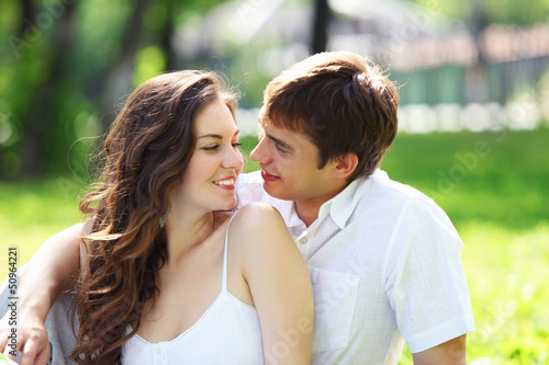 Photo: Young love Couple smiling under blue sky Young love Couple smiling under blue sky