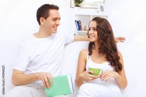 Photo: Young happy couple at hone together s Young happy couple at hone together s