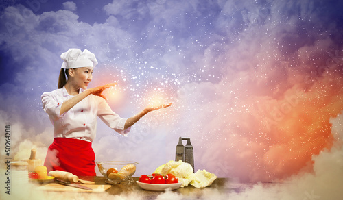 Photo: Asian female cooking with magic Asian female cooking with magic