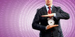 Business man holding alarmclock