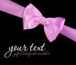 Pink ribbon bow on black background